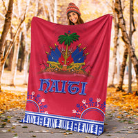 Red dashiki-style Haiti blanket with blue border and palm-and-cannons center graphic