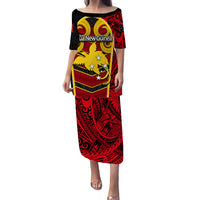 Long black dress with red and yellow tribal print, short sleeves and wide neckline.