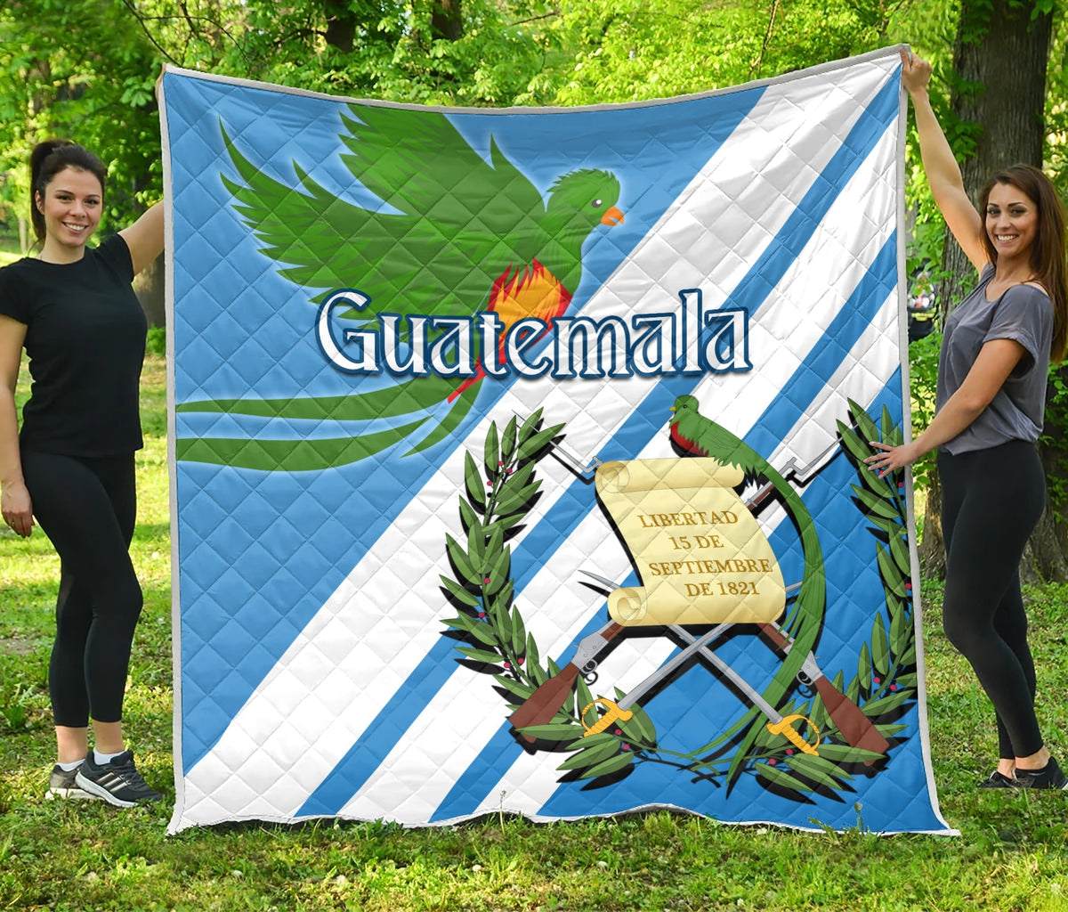 Blue Guatemala quilt with quetzal, crest, and plants, laid out flat for display