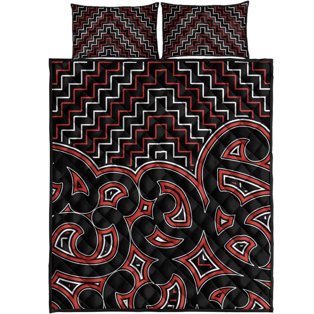 Black quilt with red and white Maori zigzag lines and tribal face motifs, quilt bed set