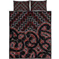 Black quilt with red and white Maori zigzag lines and tribal face motifs, quilt bed set