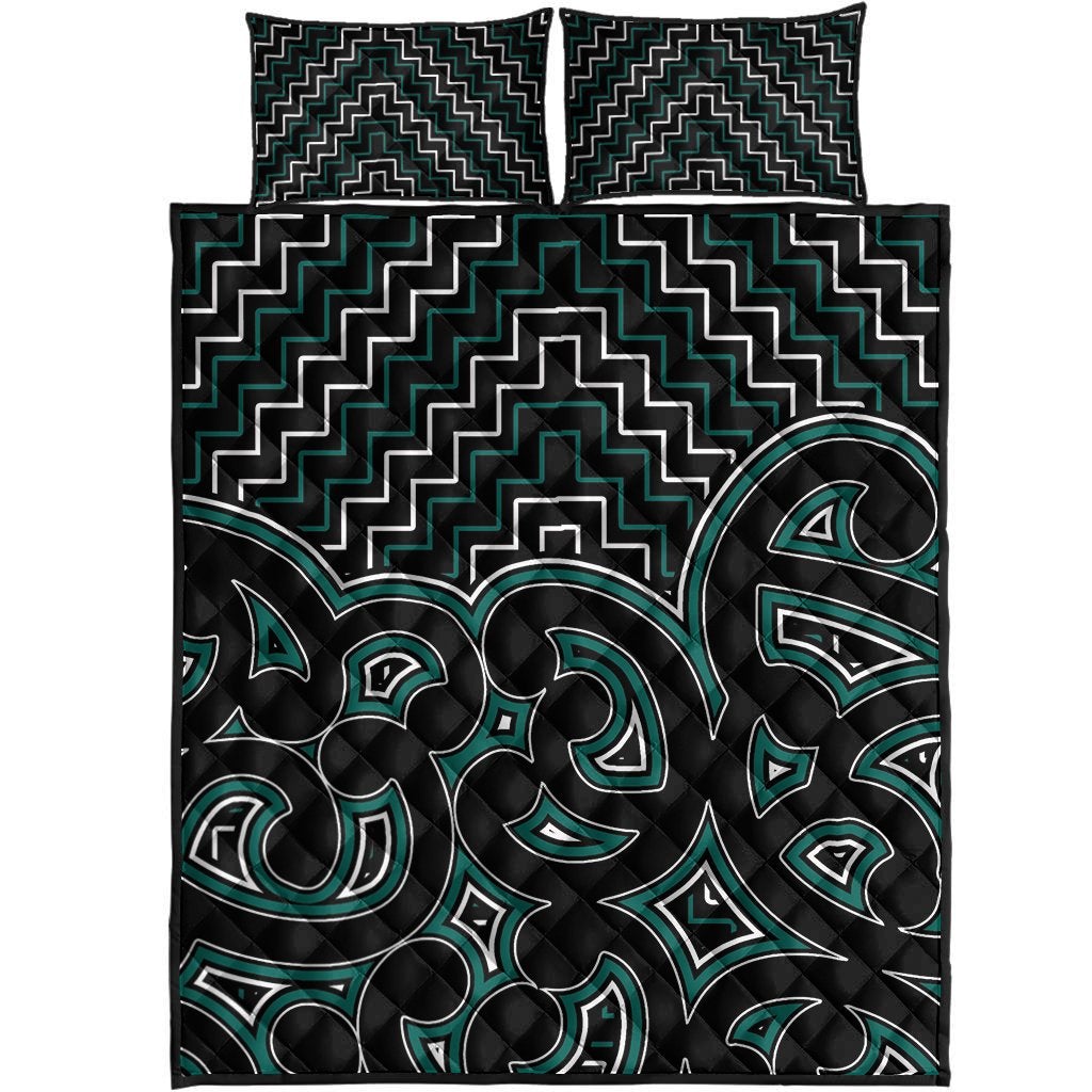 Quilt bed set top view: black quilt with green tribal motifs and pillow covers