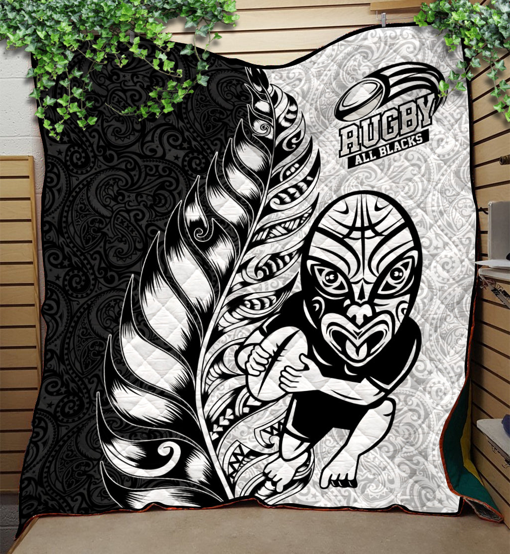 Black and white rugby quilt with Maori-style feather, All Blacks logo and emblems