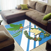 Blue and white striped rug with quetzal bird artwork and Guatemala text at center