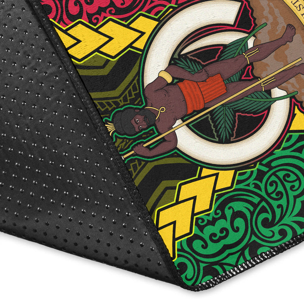 Rug close-up edge: black backing with stitched border and tribal symbols