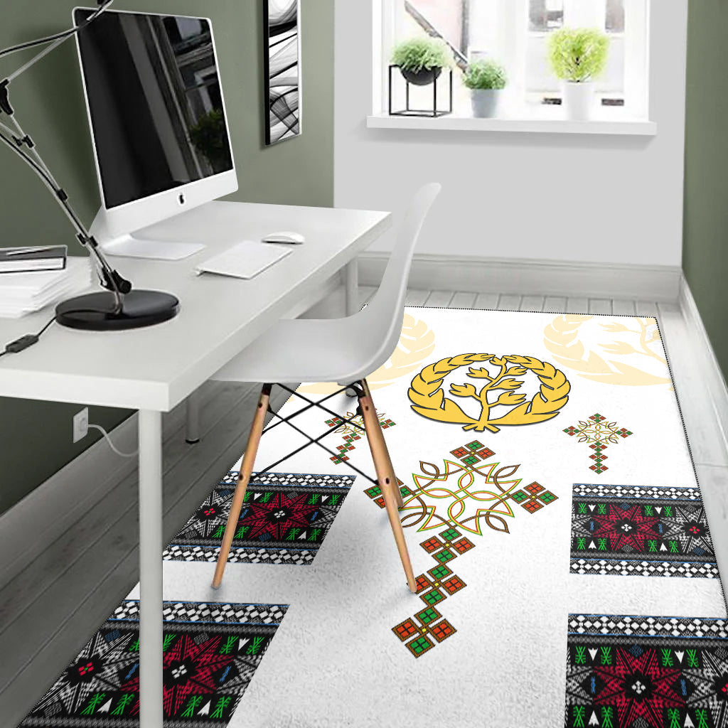 White rug with gold tree wreath and colorful square motifs across floor