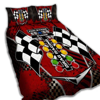 Red and black racing quilt bed set with checkered flags and colorful gear graphics