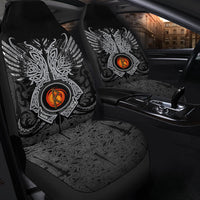 Black seat cover with large rune emblem, intricate white pattern, and orange center on seat