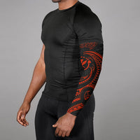 Red tribal wave arm sleeve on arm, black fabric with large tiki face and patterns