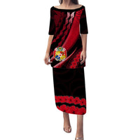 Long red-and-black patterned dress with 3/4 sleeves and scoop neckline