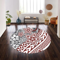 Round rug with white background and red/black floral and abstract tribal shapes