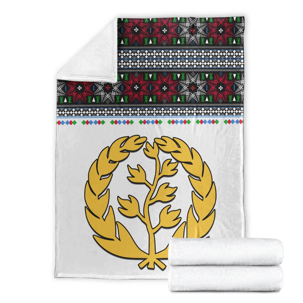 White blanket and rolled blanket: gold tree emblem with red, green, black patterned bands