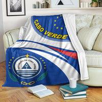 Cabo Verde blanket folded on couch, blue and white flag pattern with emblem