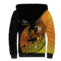 Sherpa hoodie back view with black hood, large gold fish-hook graphic, and orange sleeve panel