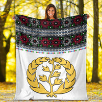 White blanket with gold tree emblem and Eritrean cross mix pattern border (red, green, black)