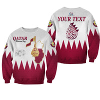 Two unisex Qatar sweatshirts: white base, maroon flag design with Qatar text