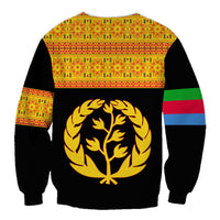 Black sweatshirt back with gold tree emblem, patterned yoke, and striped sleeves