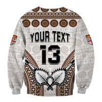Unisex sweatshirt, white with brown tapa pattern; YOUR TEXT 13 and crest