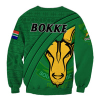 Green rugby sweatshirt back with BOKKE text, yellow emblem, and diagonal stripe design