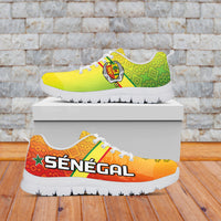 Colorful Senegal sneakers: yellow-green and orange upper, lion emblem, “SÉNÉGAL” text, white sole