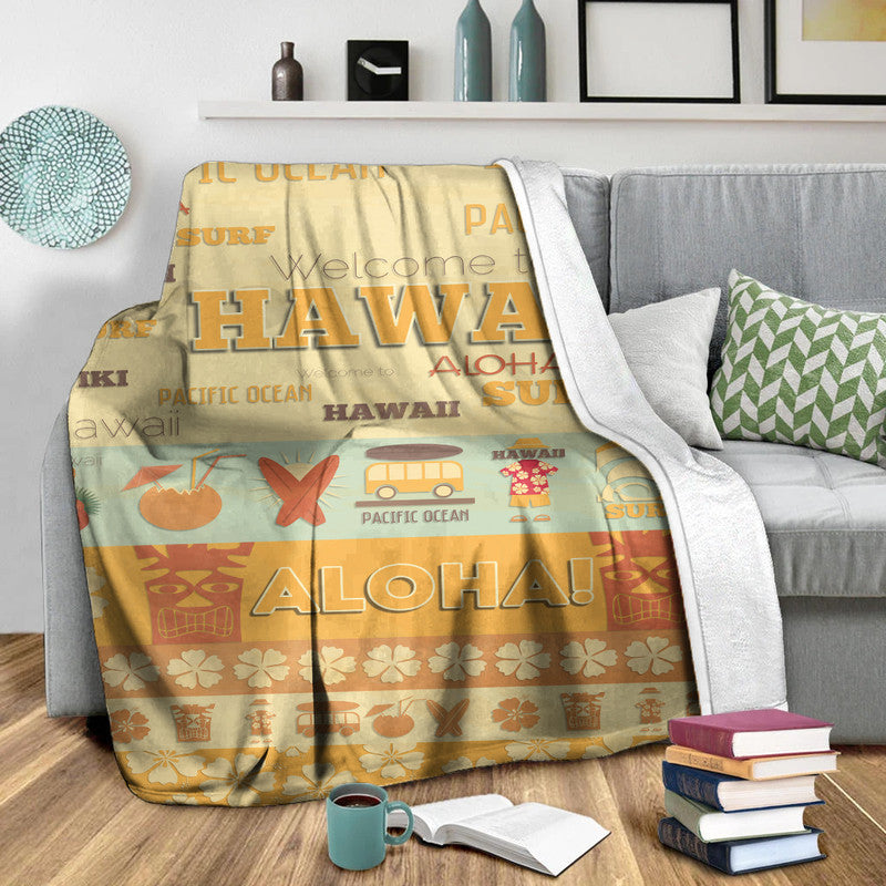 Yellow and orange Hawaii surf blanket with large “HAWAII” and “ALOHA” graphic, draped