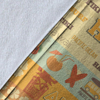 Close-up of Hawaii surf blanket print: yellow panel with boat, palm, and “Pacific Ocean” text