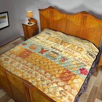Quilt blanket with quilted diamond pattern, yellow-beige and teal surf print and flowers on bed