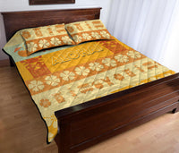 Quilt bed set quilt with ALOHA text, flowers, and surf motifs, plus matching pillows.