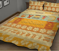 Quilt bed set with large ALOHA print, cream flowers, and orange surf icons; two shams.