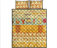 Quilt bed set with yellow, orange, and cream ALOHA print and two matching pillow shams.