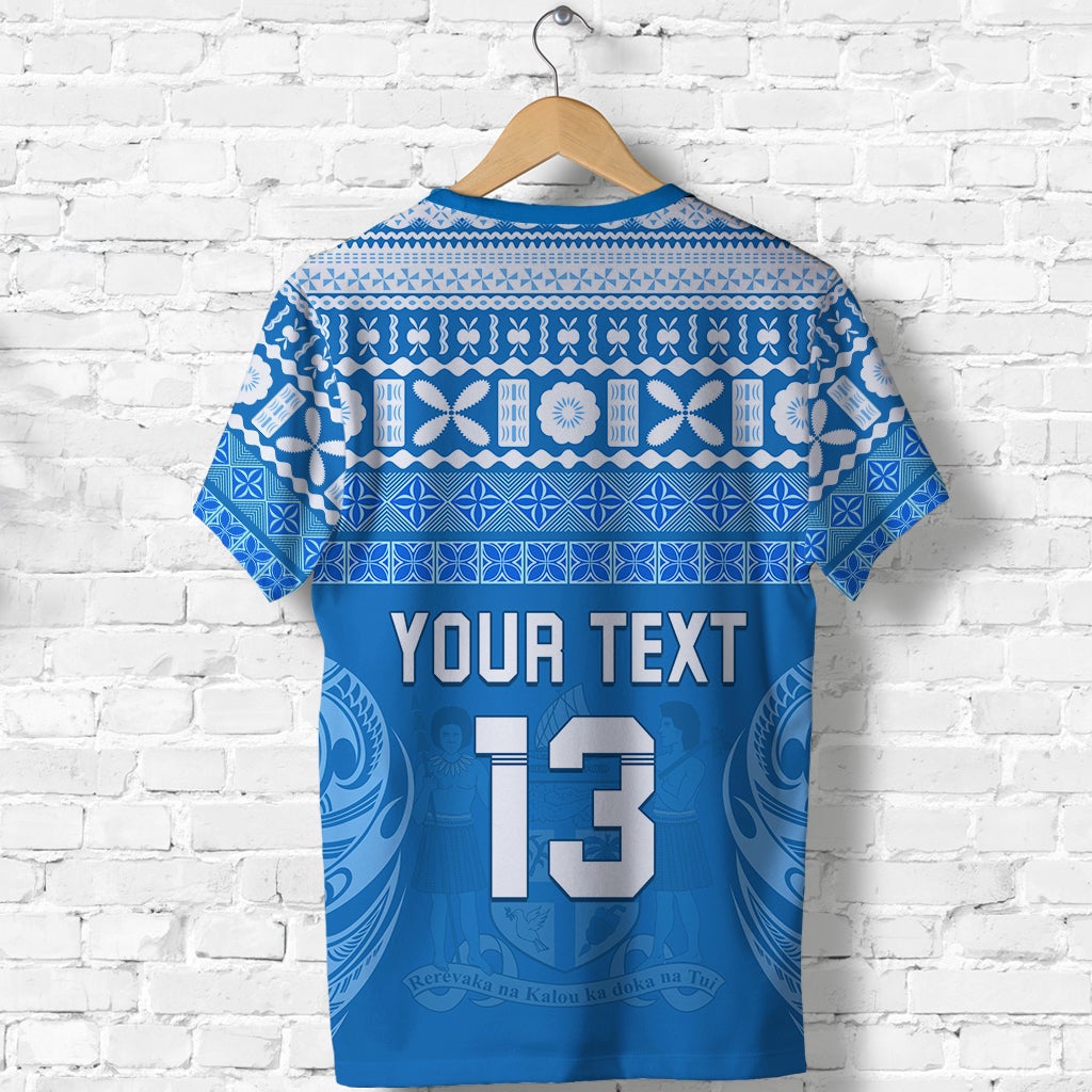 Blue T-shirt with white tapa pattern; 'YOUR TEXT 13' graphic shown on front