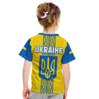 Kids yellow back Ukraine T-shirt with blue pattern, large UKRAINE text and trident