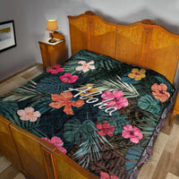 Green tropical quilt with hibiscus flowers and large 'Aloha' lettering in center