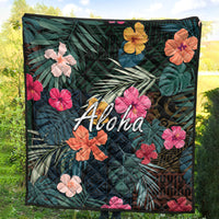 Green tropical quilt with hibiscus flowers, leaf pattern, and white 'Aloha' text