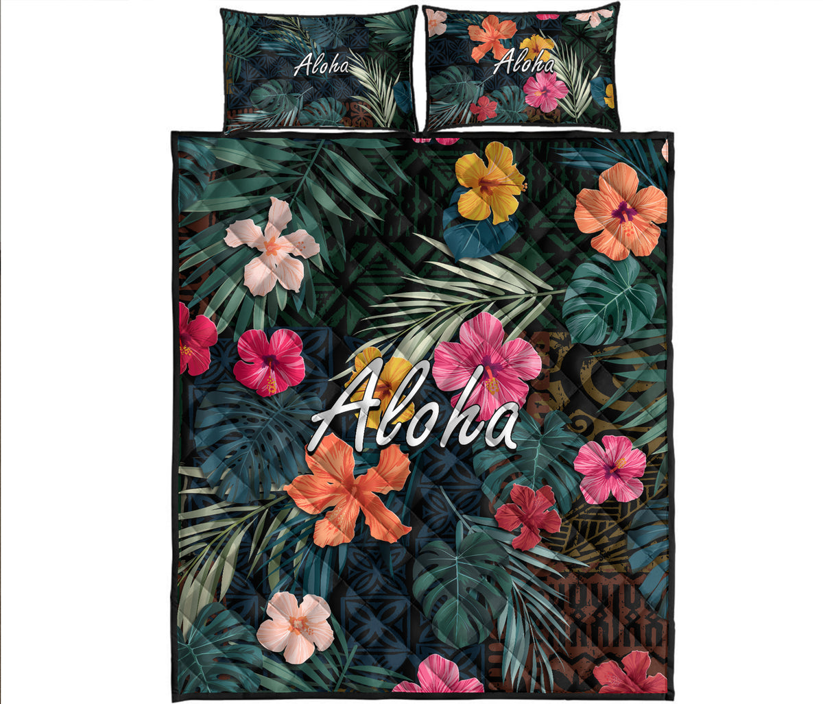 Hawaiian quilt bed set with tropical leaf print, pink/orange hibiscus and Aloha text