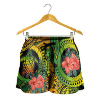 Women’s short circle shorts with green, black, yellow tribal print and red hibiscus