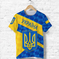 Ukraine sporty T-shirt with blue-yellow geometric pattern, front emblem and text UKRAÏNA