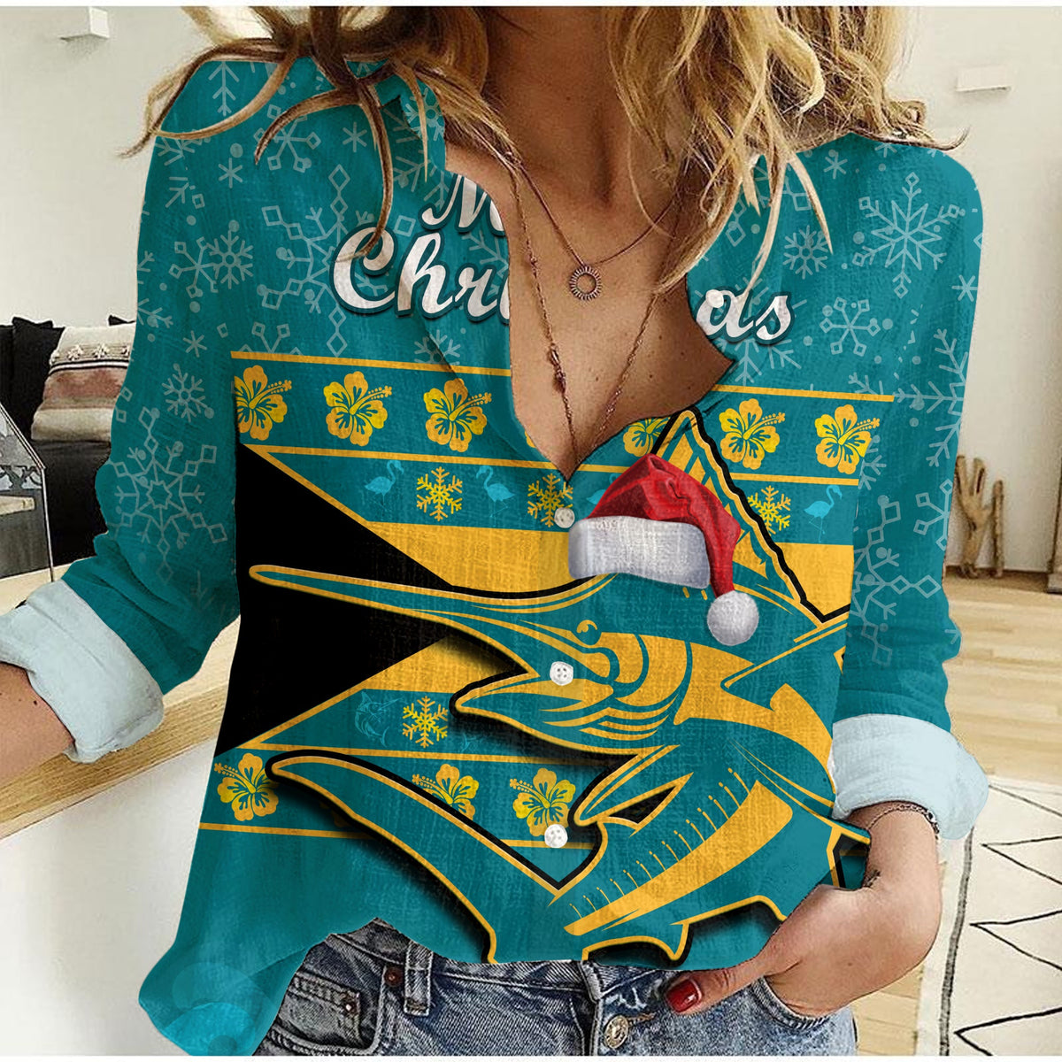 Women’s casual teal shirt with marlin graphic and red-and-white Santa hat