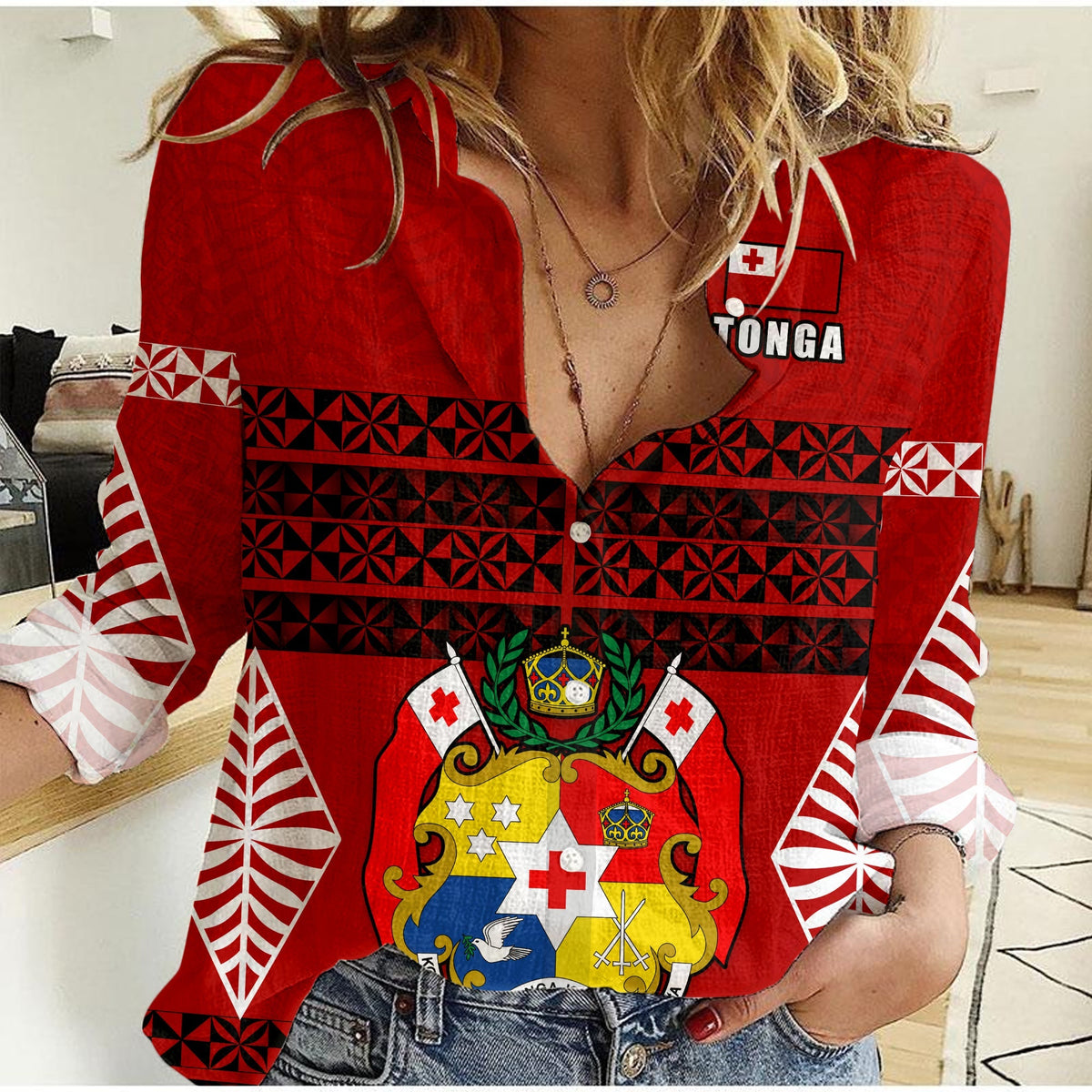 Red women’s shirt with Tongan pattern panels, crest graphic, long sleeves
