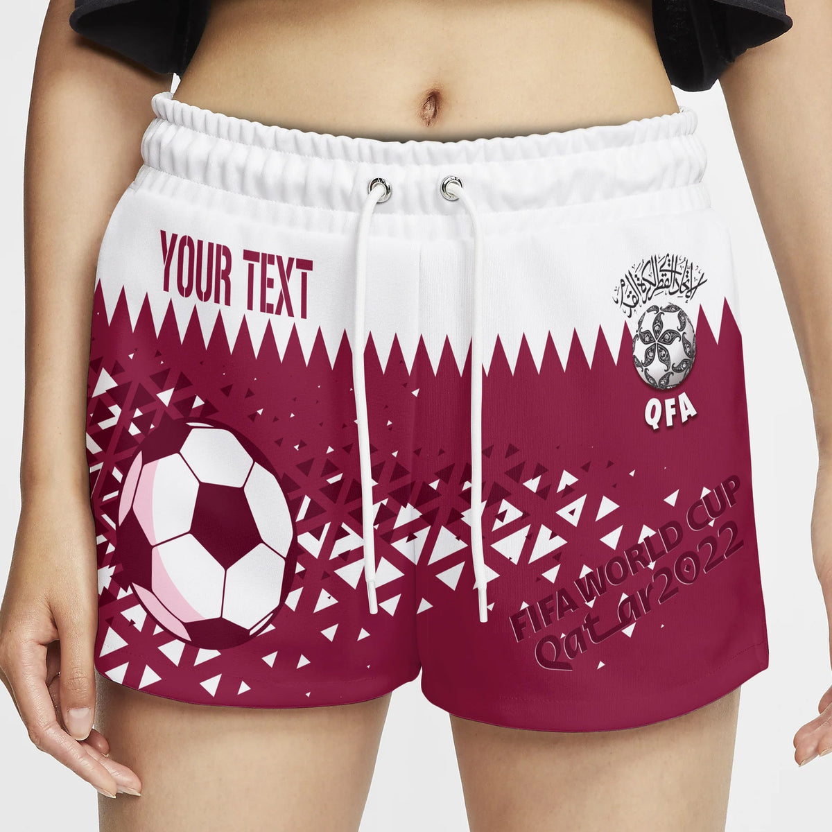 Women’s sports shorts, white waistband, maroon graphic print with “YOUR TEXT” and QFA