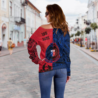 Off-shoulder sweater back view, red/blue split design with '196' date and emblem