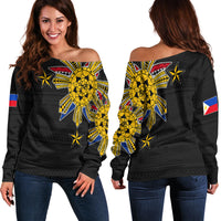 Women’s off-shoulder sweater: black long sleeves with yellow tribal sun and star print