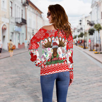 Red off-shoulder sweater back with large moose graphic and "Canada Christmas" text