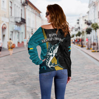 Back view off-shoulder sweater: black/teal graphic with “HAPPY EMANCIPATION DAY” text