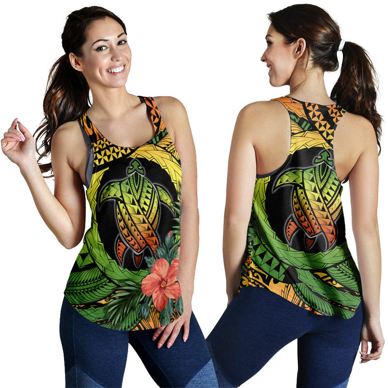 Women’s racerback tank worn by model, turtle-and-hibiscus tropical multicolor print