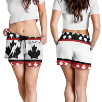 Canada women’s shorts on model, white base with red maple leaves and black tie