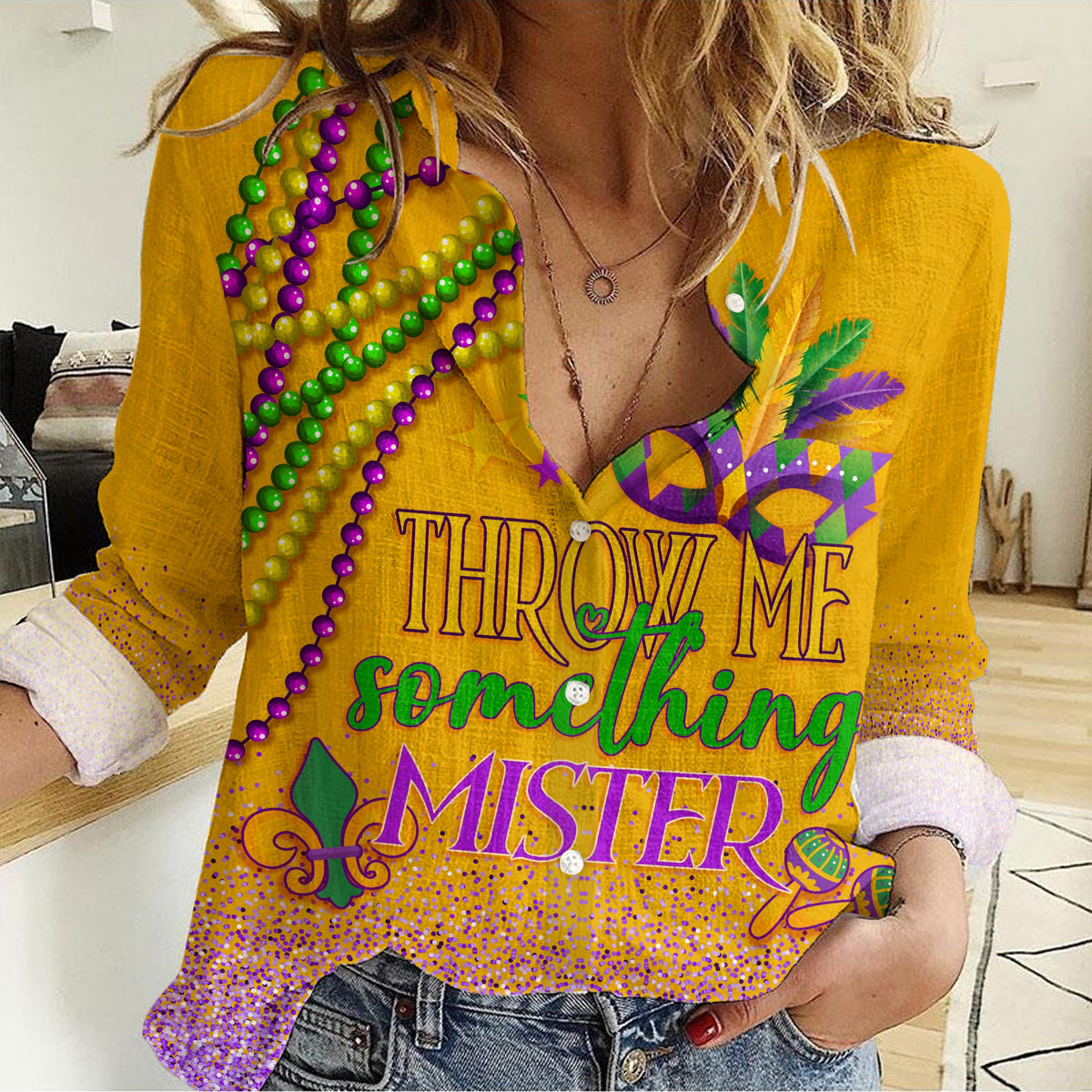 Yellow V-neck long-sleeve shirt with Mardi Gras bead graphic and “Throw Me Something”