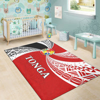 Red Tonga area rug with 'Tonga' lettering and white tapa patterns in nursery