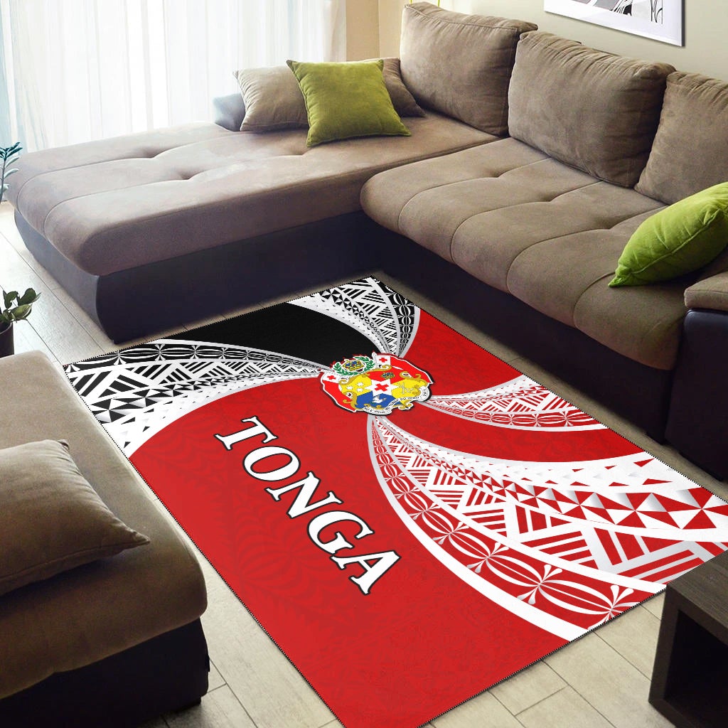 Red/white Tonga rug with 'Tonga' text and tapa patterns on floor near sofa