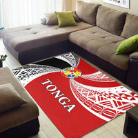 Red/white Tonga rug with 'Tonga' text and tapa patterns on floor near sofa